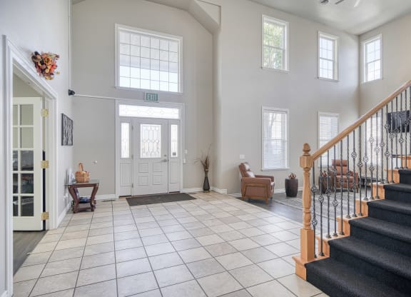 a view of the entryway of a house with a tiled floor and a staircase