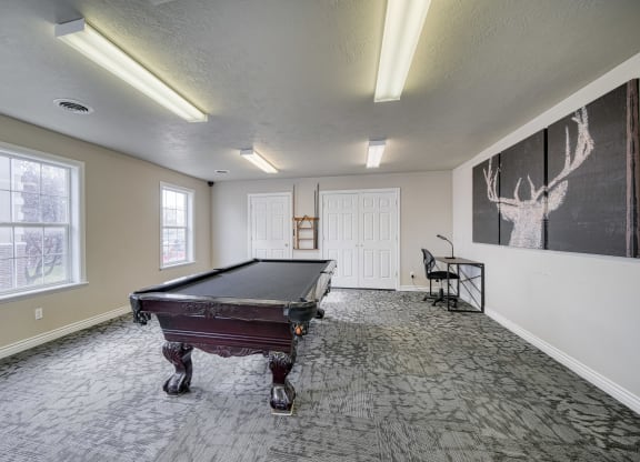 a spacious game room with a pool table