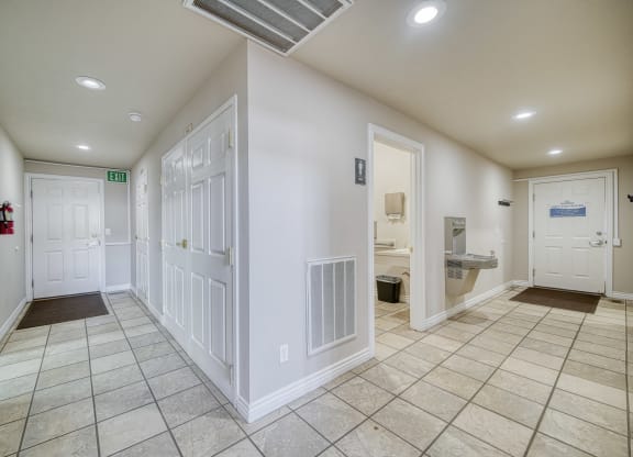 a hallway with a tiled floor and white walls