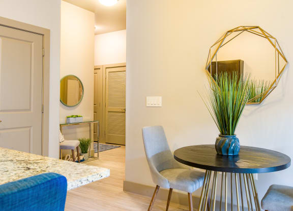 a dining room with a table and chairs and a mirror at Sugar House Apartments By Urbana, Salt Lake City, UT, 84105
