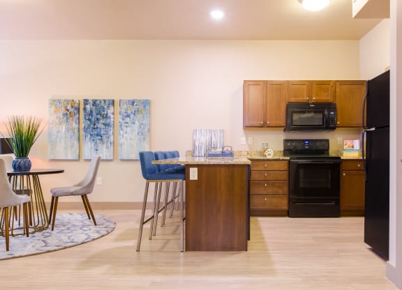 a kitchen and dining room with a table and chairs at Sugar House Apartments By Urbana, Salt Lake City, UT, 84105
