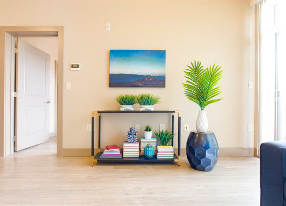 a living room with a table and a vase with plants at Sugar House Apartments By Urbana, Salt Lake City, UT, 84105