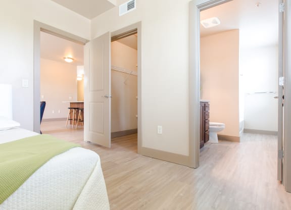 a room with a bed and a bathroom and a closet at Sugar House Apartments By Urbana, Salt Lake City, UT, 84105