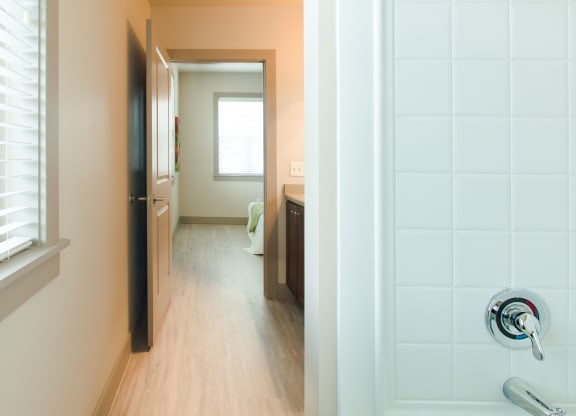 a view of a bathroom and a hallway with a door open at Sugar House Apartments By Urbana, Salt Lake City, UT, 84105
