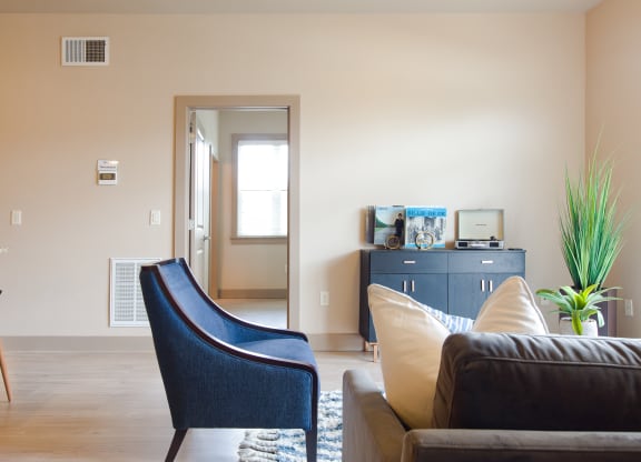 a living room with a couch chair and desk in a 555 waverly unit at Sugar House Apartments By Urbana, Salt Lake City, UT, 84105