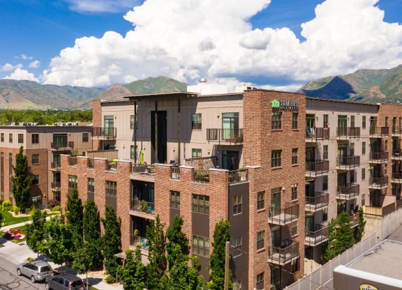 an aerial view of a large apartment complex with a mountain in the background at Sugar House Apartments By Urbana, Salt Lake City, UT, 84105