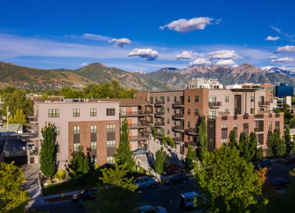 an aerial view of an apartment complex with mountains in the background at Sugar House Apartments By Urbana, Salt Lake City, UT, 84105
