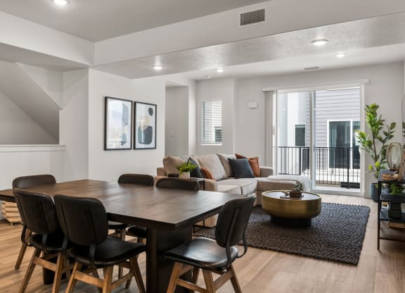 a living room with a dining room table and chairs
