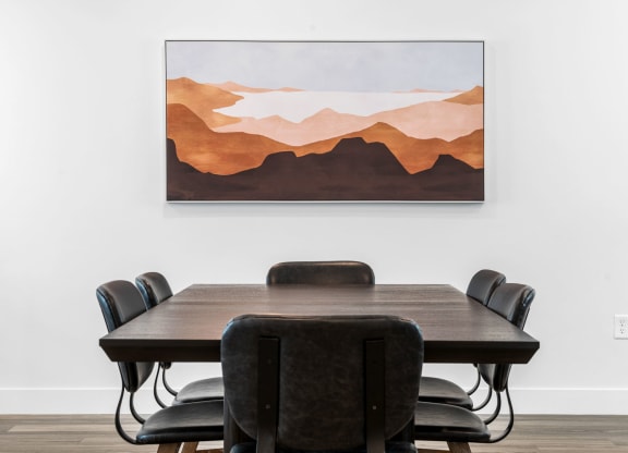 a painting of a conference room with a table and chairs
