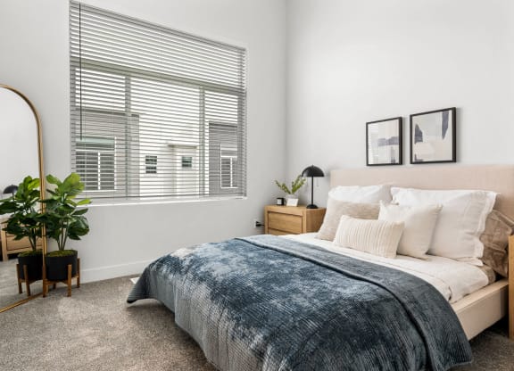 a bedroom with a large bed and a large window
