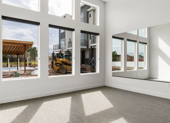 an empty room with a bulldozer in the background