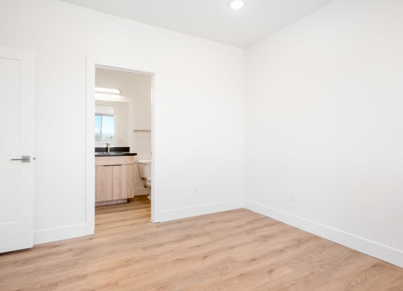 a living room with white walls and a wooden floor