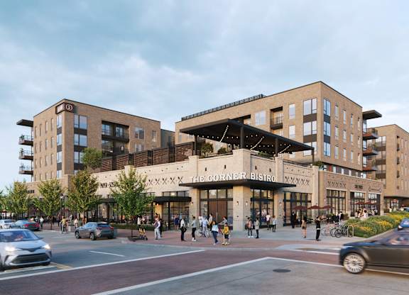 A street view of a building with cars and people walking.