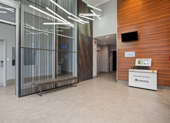 the lobby of a building with a large glass window and a reception desk
