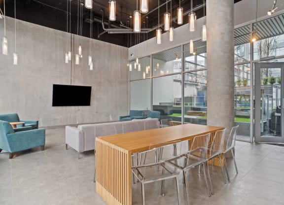 a communal table and chairs in a lobby of a building
