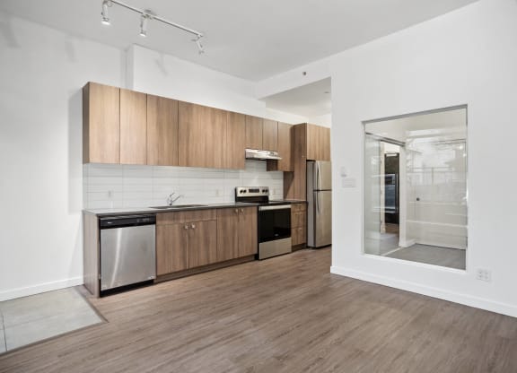 a kitchen with wooden cabinets and stainless steel appliances and a glass door