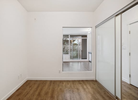 a living room with white walls and a sliding glass door