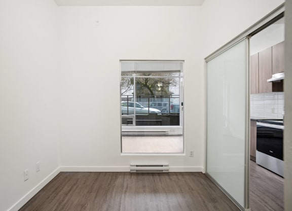 a living room with a window and a glass door