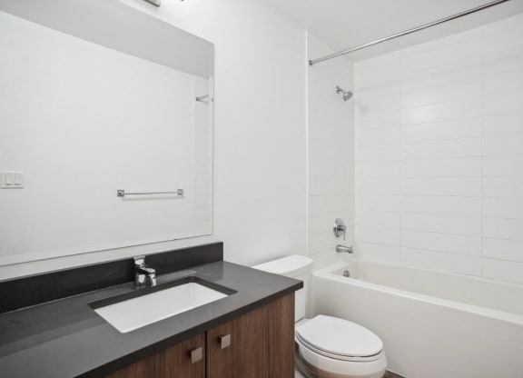 a bathroom with a sink toilet and a tub