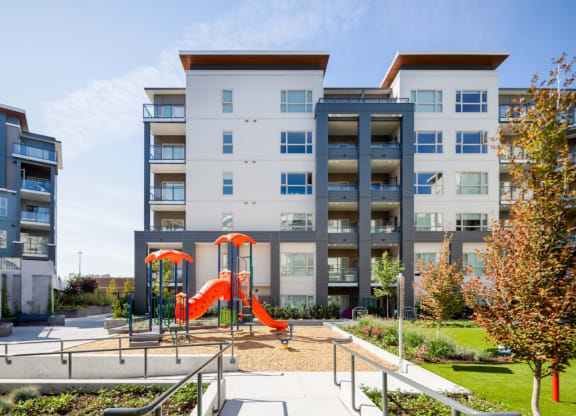 an outdoor playground in front of an apartment building