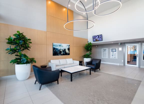 a lobby with a couch and chairs and a table