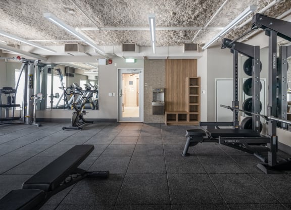 a gym with weights machines and a door