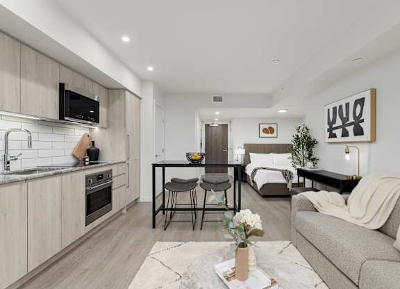 A modern kitchen with a dining area and a living room.