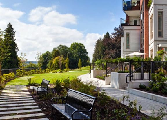 a park with benches in front of a building