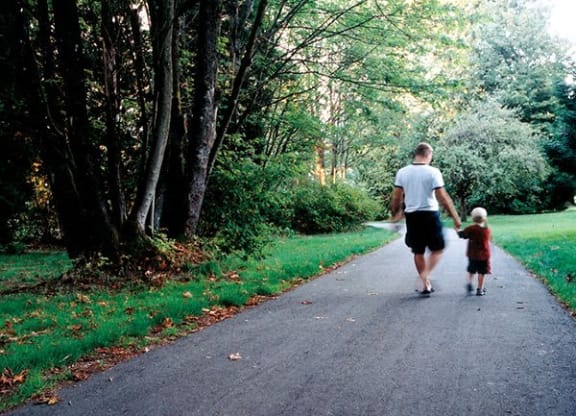 a man and a child walking down a road