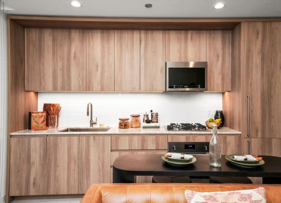 a kitchen with wooden cabinets and a black table