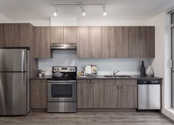 a kitchen with stainless steel appliances and wooden cabinets
