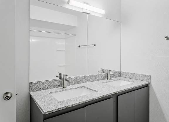 A bathroom with a sink and mirror.