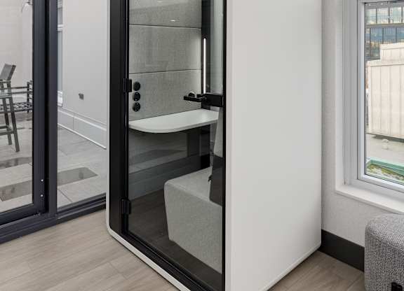 A white bathroom with a glass door and a window.