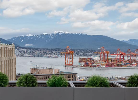 A view of a harbor with mountains in the background.