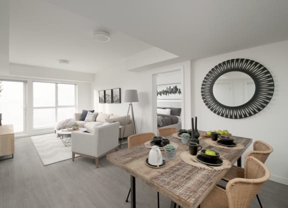 a living room and dining room with a table and chairs