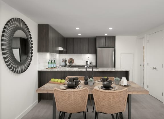 a kitchen and dining area with a wooden table and chairs