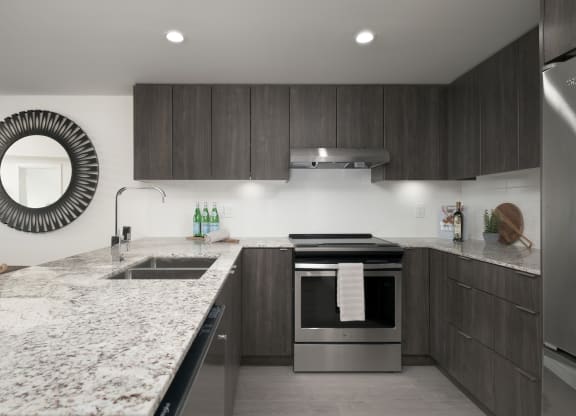 a modern kitchen with marble counter tops and wooden cabinets