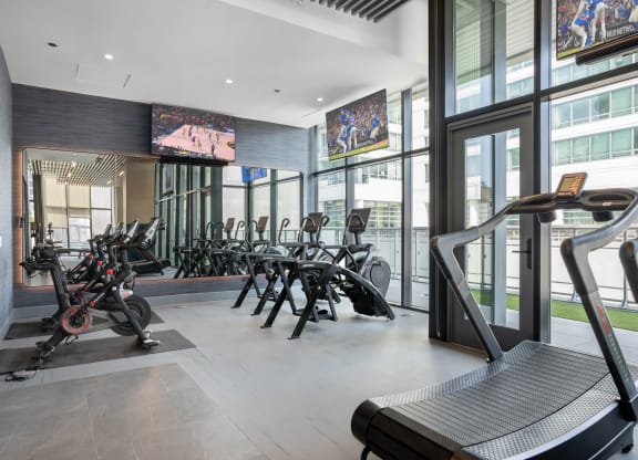 a room filled with lots of cardio equipment and a treadmill