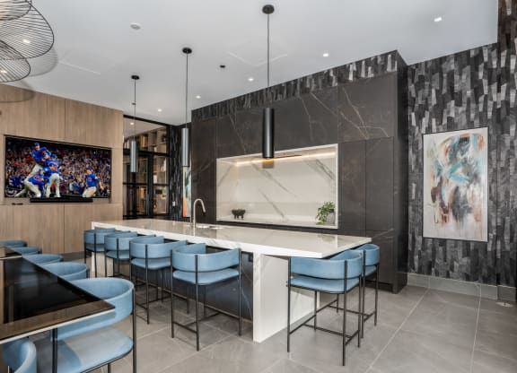 a kitchen with a large center island with a marble countertop
