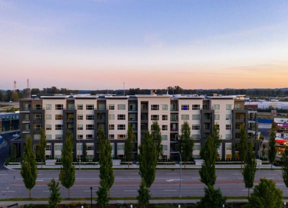 an aerial view of an apartment building in a parking lot