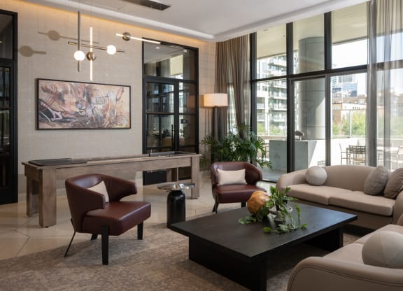 a living room filled with furniture and a large window