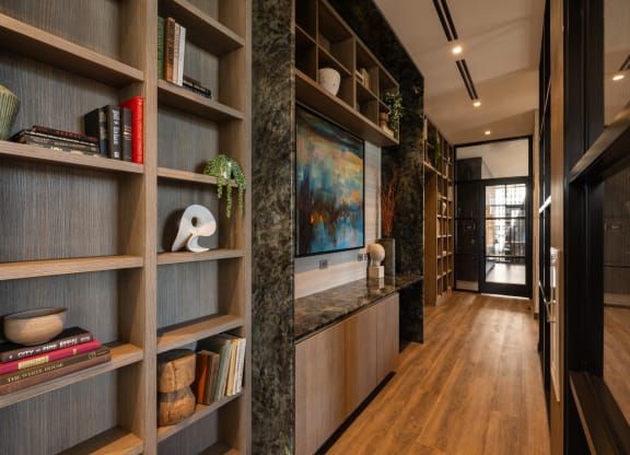 a hallway with wooden shelves and a marble countertop