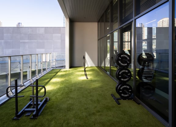 a room with an indoor grassy area and a view of the water