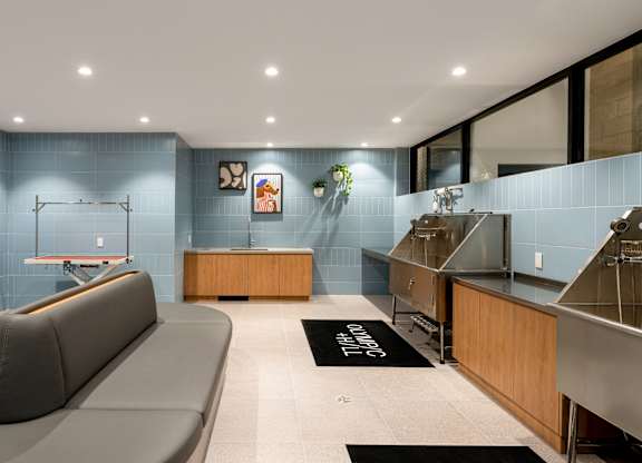 A modern living room with a grey sofa and a wooden cabinet.