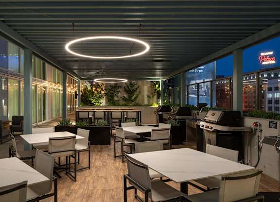 A restaurant with tables and chairs and a bar area.