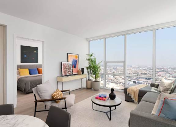 A living room with a large window overlooking the city.