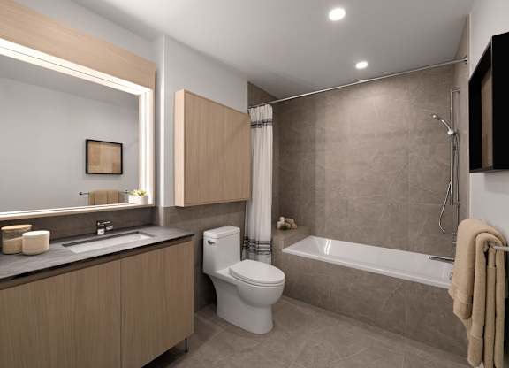 A modern bathroom with a toilet, sink, and bathtub.