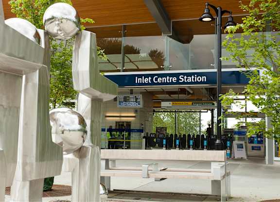 A train station with a sign that says Inlet Centre Station.