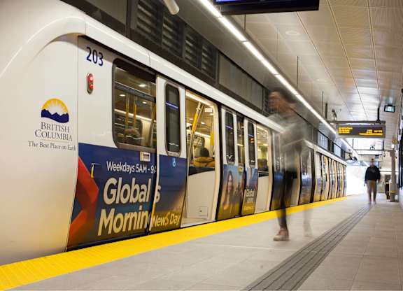 A train with the number 203 on it is pulling into a station.