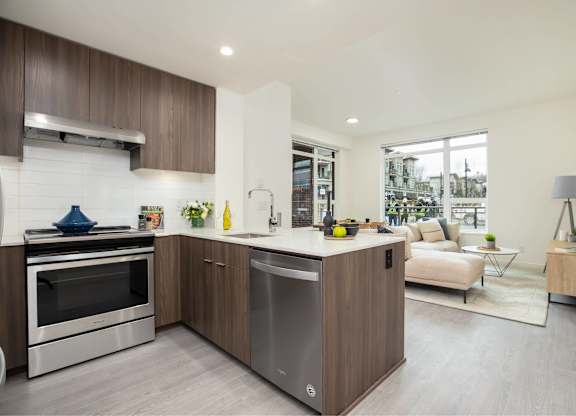 A modern kitchen with a stainless steel dishwasher and oven.
